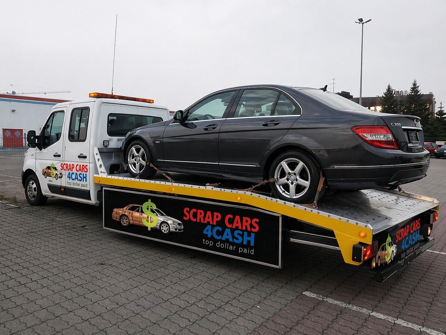 Scrap Cars 4 Cash flatbed tow truck removing a scrap car in Ajax Ontario Durham Region